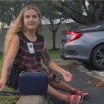 A woman in a striped shirt and wearing red sandals sits on the curb of a parking lot