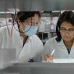 Nita, the central figure in 'A Shot at History', with one of her lab partners