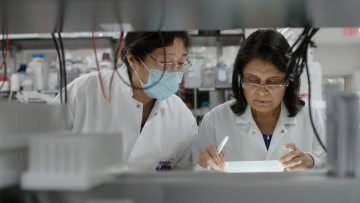Nita, the central figure in 'A Shot at History', with one of her lab partners
